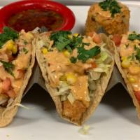 Fish Tacos · Three soft tacos filled with tilapia fillet, tomatoes and cheese. Served with Mexican rice a...
