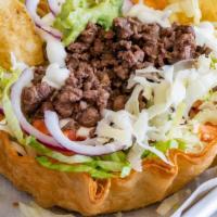 Taco Salad · Served with rice, beans, lettuce, tomato, sour cream, cheese, and guacamole.