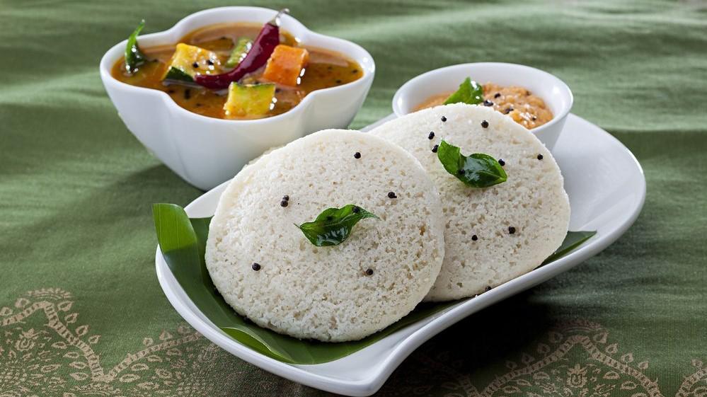 Idli Sambhar · Idli - a type of rice cake made by steaming a batter consisting of fermented black lentils (de-husked) and rice. Sambhar - a lentil-based vegetable stew or chowder cooked with a tamarind broth.