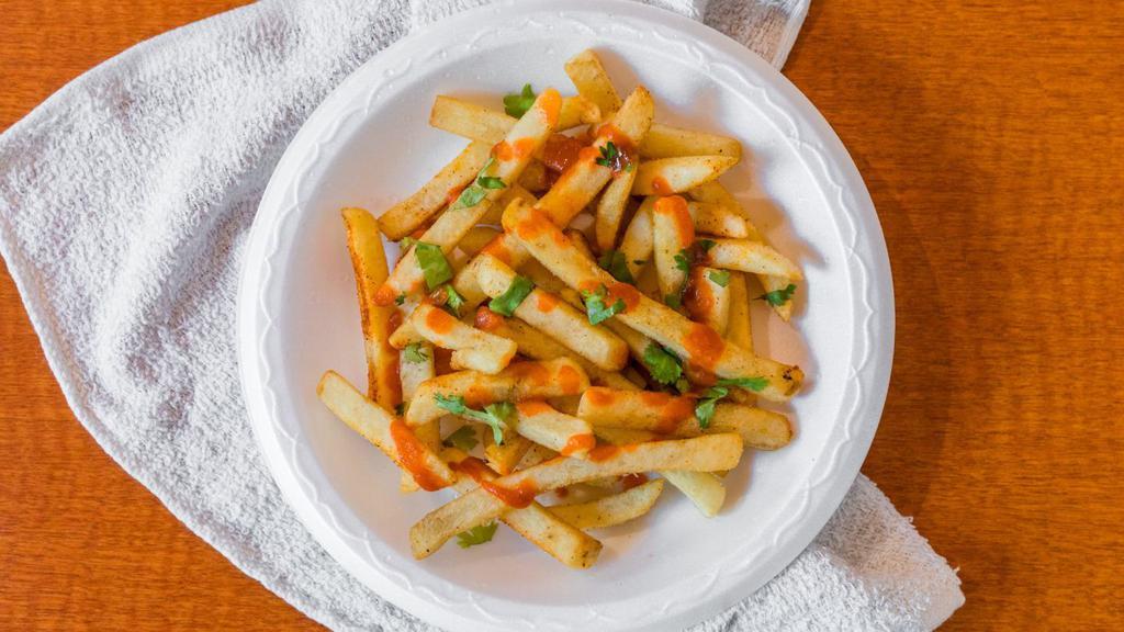 Masala Fries · Potato fries sprinkled with Indian spices and sriracha sauce to taste.