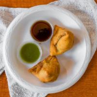 Samosa · A very popular Indian snack. Triangular shaped, fried dish with a savory filling of spiced p...