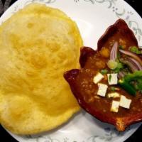 Choley Bhature · A combination of chana masala (white chickpeas) and bhatura, a fried bread made from maida f...