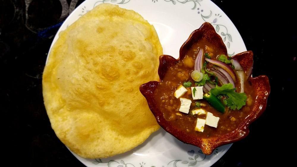 Choley Bhature · A combination of chana masala (white chickpeas) and bhatura, a fried bread made from maida flour (soft wheat).