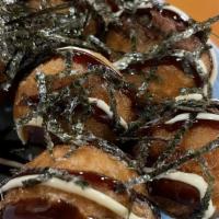 Takoyaki · Deep fried japanese octopus balls with sauce mayonnaise bonito and seaweed on top.