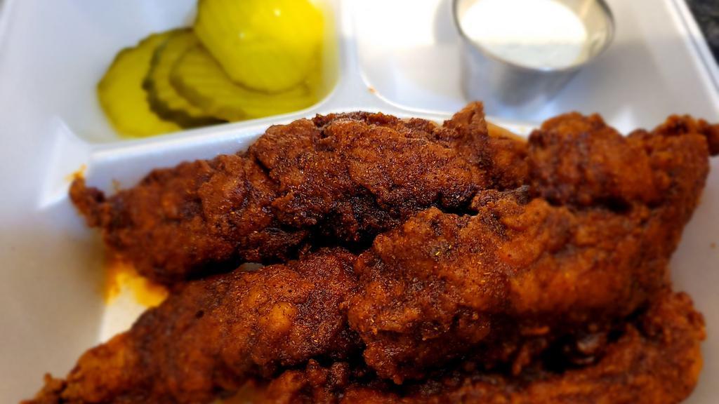 Nashville Hot Chicken Strips · Amazing, tasty, and spicy Nashville Hot Chicken Strips!  Get 4 strips on top of white bread, with pickles, and homemade ranch seasoning.