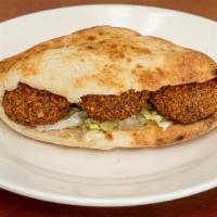 Falafel Sandwich · Freshly made falafel placed in samoon bread and topped with tomatoes, onions, lettuce, parsl...