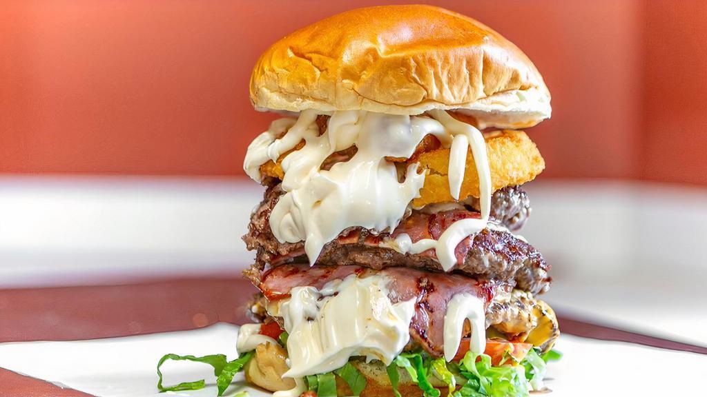 Moe'Z Beast Burger · Triple Beef Patty, Bacon, Onion Ring, Mozzarella Sticks, Lettuce, Tomatoes, Onions, Pickles, Moe'z Sauce, American Swiss Cheese.