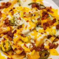 Loaded Fries · New. Steak Cut Fries loaded with Jalapeno, Mozzarella, Cheddar, Bacon, and a side of Ranch.