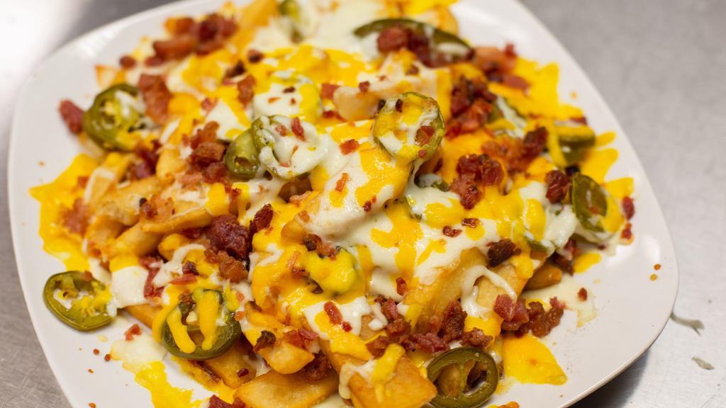Loaded Fries · New. Steak Cut Fries loaded with Jalapeno, Mozzarella, Cheddar, Bacon, and a side of Ranch.