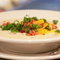 Baked Potato Soup · House-made baked potato soup.  Served with Bacon, green onion and cheddar cheese.