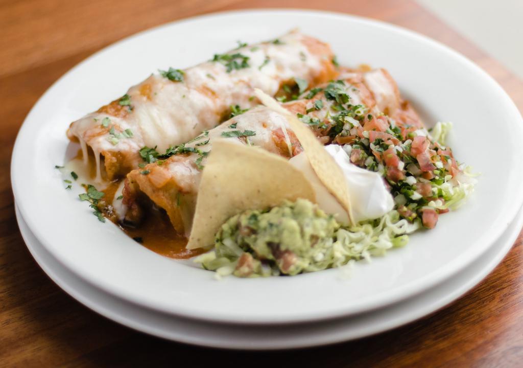 The Enchilada Plate · Corn tortilla filled with grilled chicken, Monterey jack, enchilada red sauce and sour cream, guacamole, tomatoes.