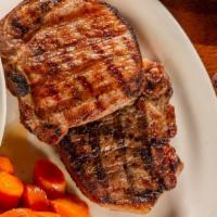 Grilled Pork Chops · Hardwood grilled and served with your choice of two sides. Mashed potatoes and baked beans a...