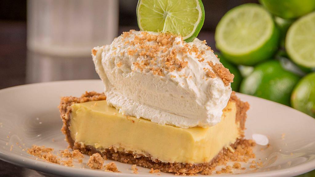 Key Lime Pie · Graham cracker, walnut and pecan crust filled with natural key lime custard, topped with homemade whipped cream.