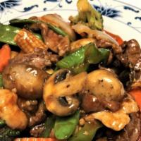 Triple Crown · Shrimp, beef & chicken stir fry with veggie in a house brown sauce.