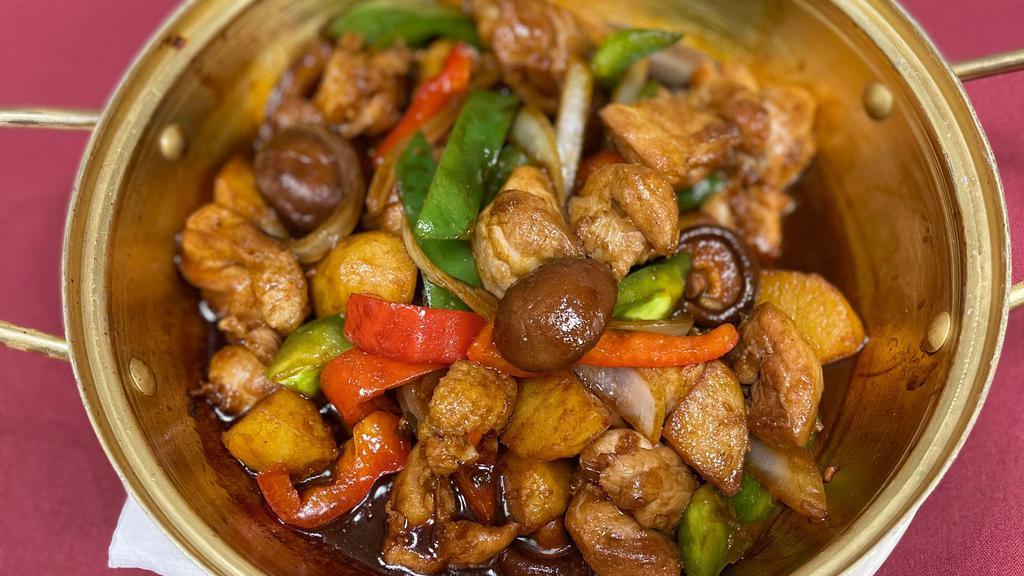 Braised Chicken 黄焖鸡 · Bone in chicken with bell peppers, onion and Shiitake mushroom in chef's special sauce.