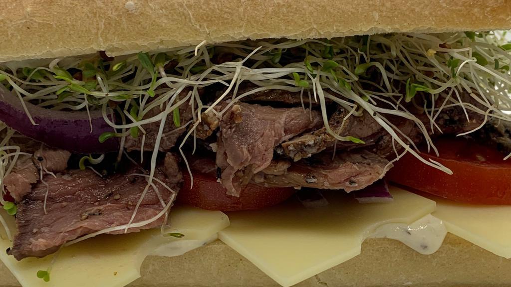 Roast Beast Sandwich · House-roasted beef with homemade horseradish cream sauce, Swiss, tomato, sprouts and red onion on a local artisan French baguette.