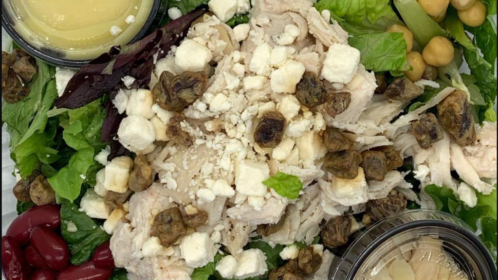 Hunters Salad · Chicken breast, dates, almonds, feta, chickpeas and kidney beans on a bed of mixed greens with citrus vinaigrette.
