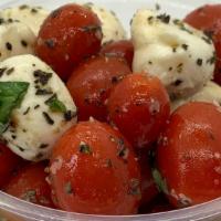 Caprese Salad · Ripe cherry tomatoes with fresh mozzarella, olive oil, basil and balsamic glaze.