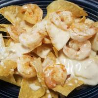 Grilled Shrimp Nachos (Full) · A bed of crispy tortilla chips smother with our exquisite cheese dip topped with succulent g...