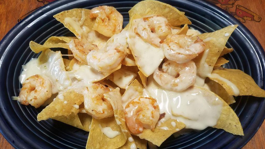 Grilled Shrimp Nachos (Full) · A bed of crispy tortilla chips smother with our exquisite cheese dip topped with succulent grilled shrimp. add fajita veggies for a bit more