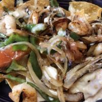Grilled Shrimp Nachos (Half) · A bed of crispy tortilla chips smother with our exquisite cheese dip topped with succulent g...
