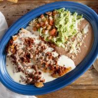 Pollo Michoacano · A grilled chicken breast topped with chorizo and cheese sauce and served with guacamole sala...
