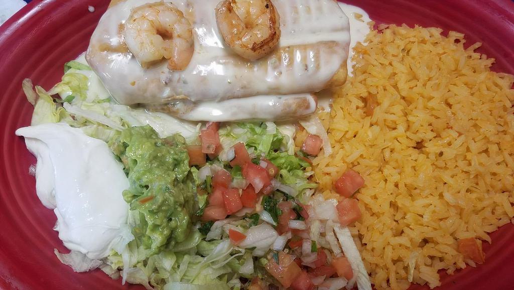 Shrimp Chimichanga · Grilled shrimp and cheese wrapped in a flour tortilla, deep-fried, and covered with cheese dip. Served with a guacamole salad, rice, and beans.