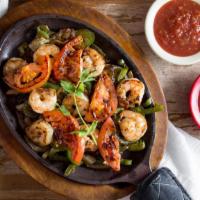 Shrimp Fajitas · Shrimp, tomatoes, bell peppers, and onions are grilled to perfection and served with lettuce...