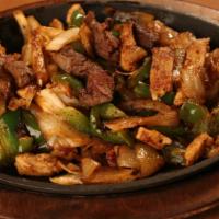 Combo Fajitas · Marinated strips of chicken and steak with grilled peppers and onions.