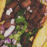 Lengua Taco · Beef tongue with onions and cilantro.
