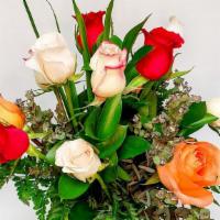 1 Dozen Mixed Color Roses · One dozen mixed roses arranged with assorted greenery in a clear vase.  Perfect for any occa...