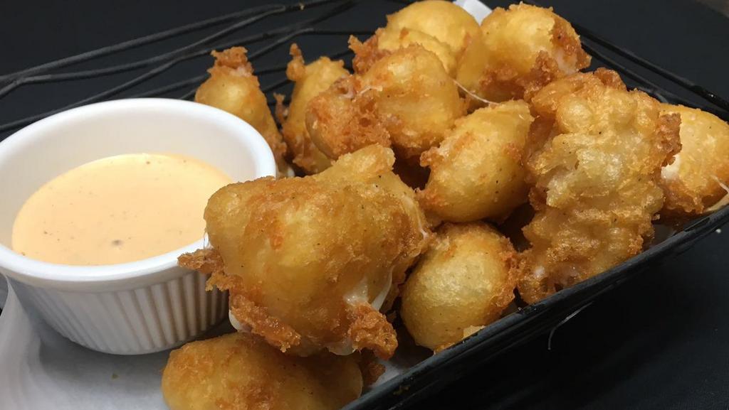 Cheese Curds · A Wisconsin favorite! Haus battered white cheese curds, naga-wicked pale ale beer batter, southwest ranch dipping sauce