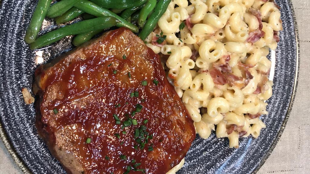 Meatloaf · special blend of veal, beef, and pork mixed with haus seasoning and baked with a brown sugar bbq glaze, served with bacon mac & cheese and green beans