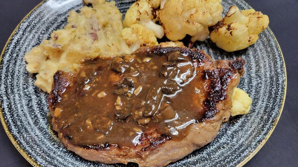 Ribeye · 14 oz. seasoned and seared to your preferred temperature with garlic mushroom demi-glace, sour cream chive mashed potatoes and roasted cauliflower