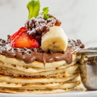 Chunky Monkey Pancakes · Topped with chocolate chips banana slices, walnuts, and chocolate syrup