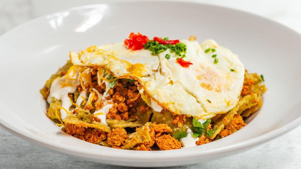 Chilaquiles Verde · Corn tortilla chips, salsa verde, chicken chorizo, avocado, pepper jack cheese, red onion, and sour cream. Topped with two eggs any style.