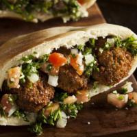 Falafel Pita · Perfect pita filled with falafel, juicy tomatoes, onions, cucumbers and tahini sauce. Served...