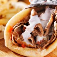 Beef Shawarma Pita · Mouthwatering Beef Shawarma made artfully in a pita with lettuce, tomatoes, onions, cucumber...