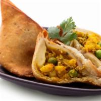 Vegetarian Samosas · Four pieces of filo dough filled with carrot, green onions, corn and potatoes.