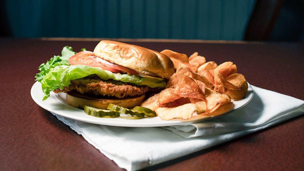 Pork Tenderloin · Breaded pork cutlet, deep fried till golden brown, finished with lettuce, tomato, and mayonnaise. Served on Rotella’s bun.