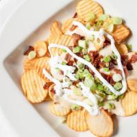 Irish Nachos · Fried cottage chips smothered in melted Cheddar cheese, topped with bacon, sour cream, Paddy...