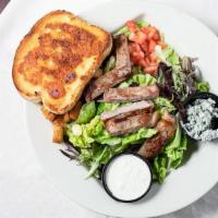 Steak Salad · Sirloin steak, nestled on a bed of fresh greens, topped with Bleu cheese crumbles and tomato...