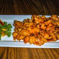 Orange Chicken · Tender slices of chicken lightly battered and caramelized in a tangy orange sauce.