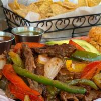 Steak Fajitas Lunch · Grilled Steak, bell peppers, onions, rice, beans, salad