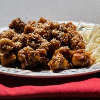 Crispy Sesame Chicken · Crispy chunks of chicken sautéed in a tangy brown sauce sprinkled with sesame seeds.