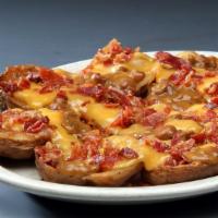 Potato Skins · Smothered with cheddar and jack cheese and topped with bacon.