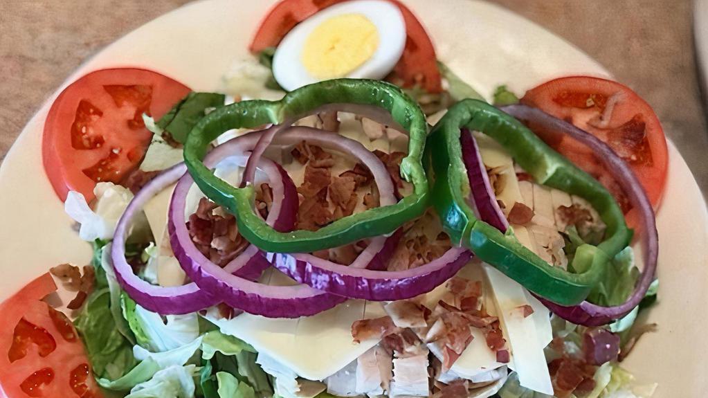 Clubhouse Salad · Topped with oven roasted turkey, chopped bacon, swiss cheese, hard-boiled egg, onions, green peppers and tomatoes.