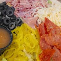 Antipasto Salad · Lettuce, shredded mozzarella, black olive, pepperoni, ham, and pepperoncinis. Served with It...