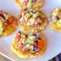 Patacones Picantes · Fried plantains covered in pico de gallo salsa and topped with a hot aji verde sauce.  The p...