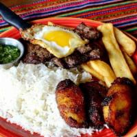 Carne A La Plancha · Gluten-free. Grilled steak topped with a fried egg. Served with white rice and maduro fritos...
